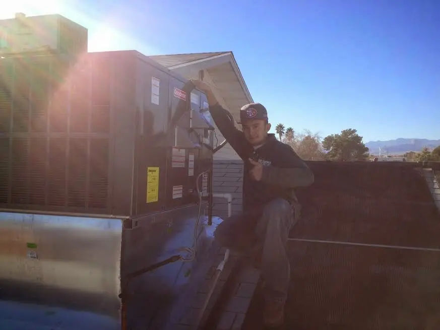 HVAC technician performing HVAC Inspection on a rooftop unit in Lake Magdalene